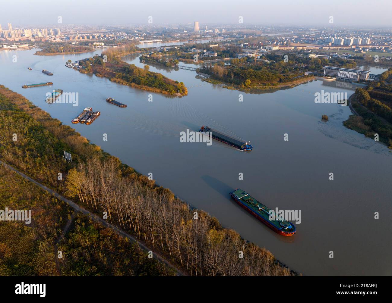 HUAI'AN, CHINA - NOVEMBER 19, 2023 - Cargo ships sailing in the main irrigation channel of northern Jiangsu in Huai 'an city, Jiangsu Province, China, Stock Photo