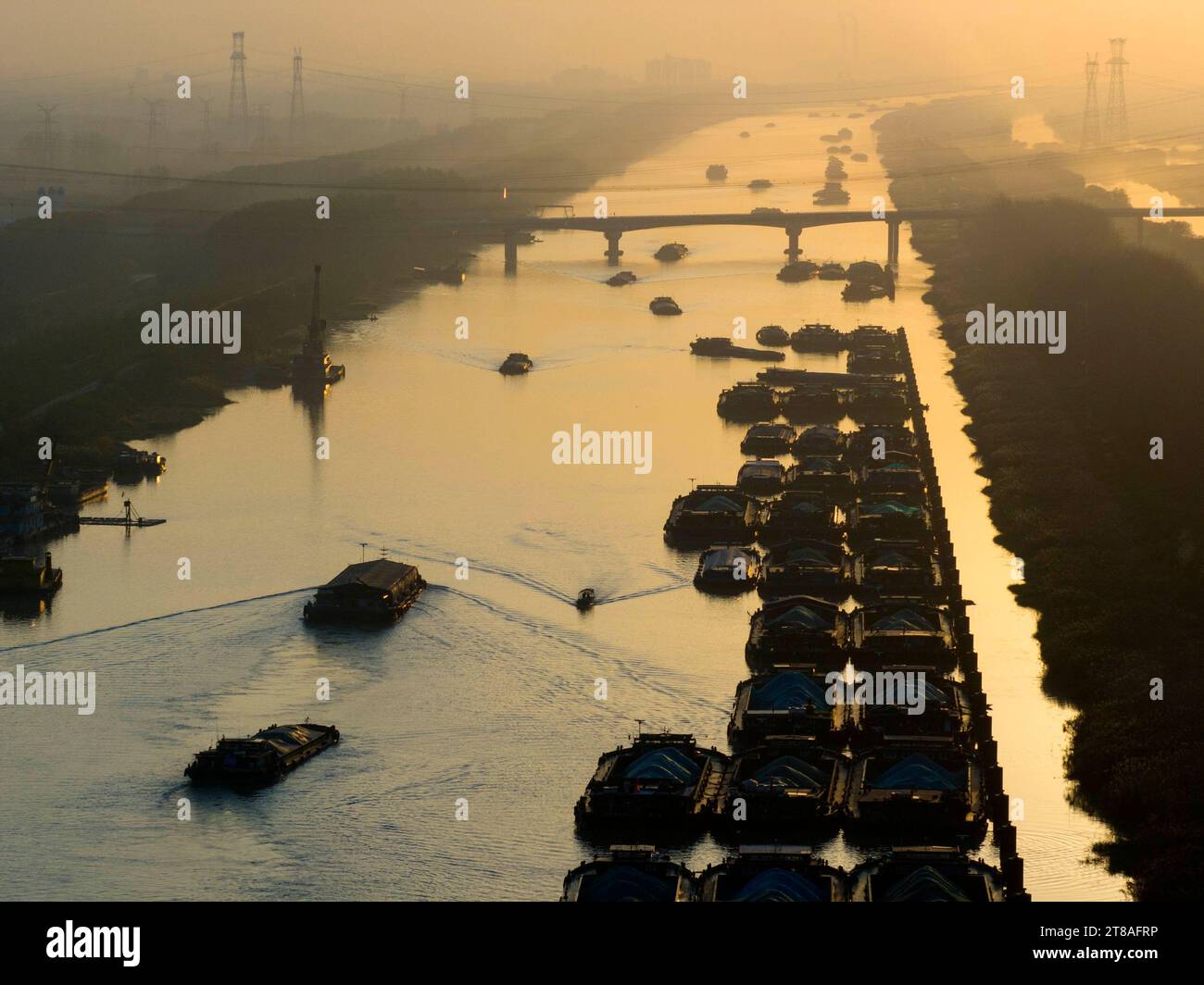 HUAI'AN, CHINA - NOVEMBER 19, 2023 - Cargo ships sailing in the main irrigation channel of northern Jiangsu in Huai 'an city, Jiangsu Province, China, Stock Photo