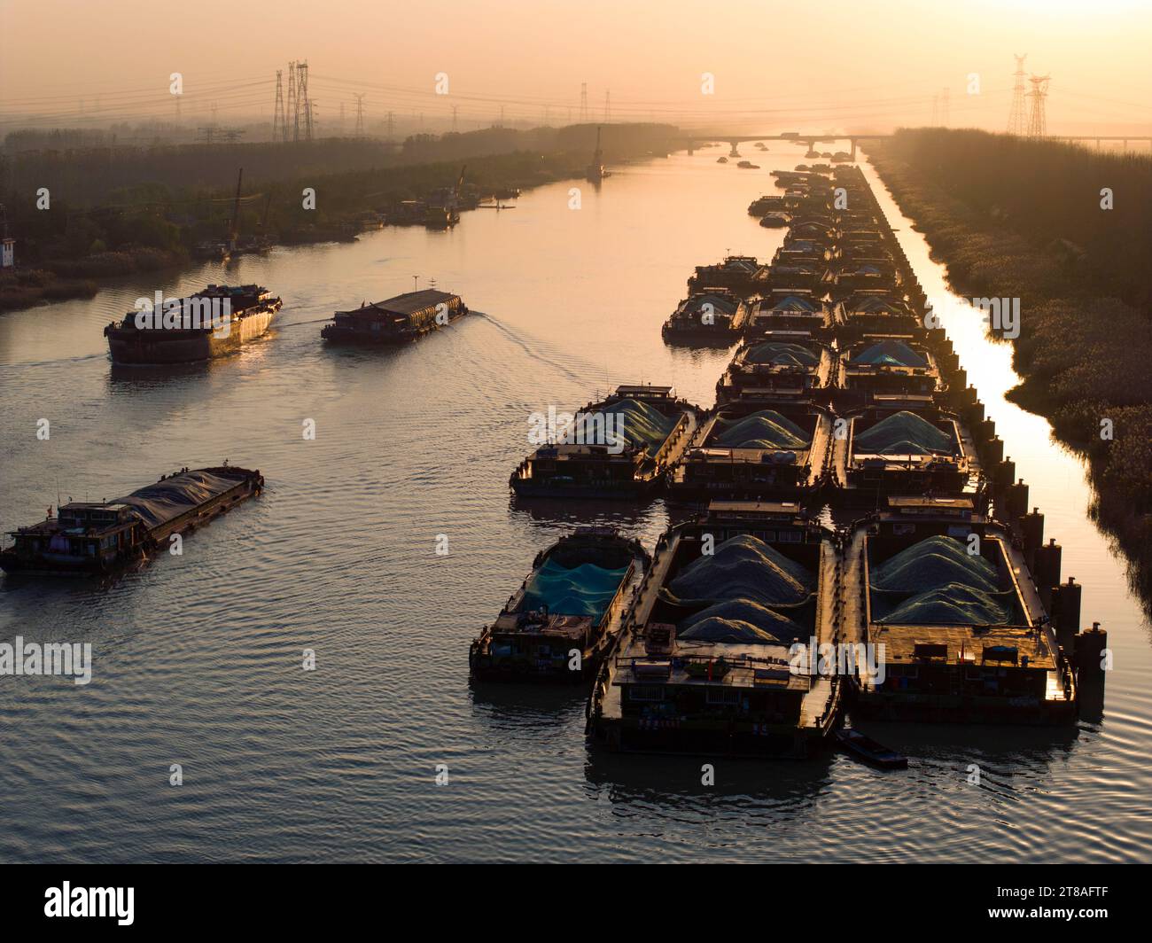 HUAI'AN, CHINA - NOVEMBER 19, 2023 - Cargo ships sailing in the main irrigation channel of northern Jiangsu in Huai 'an city, Jiangsu Province, China, Stock Photo