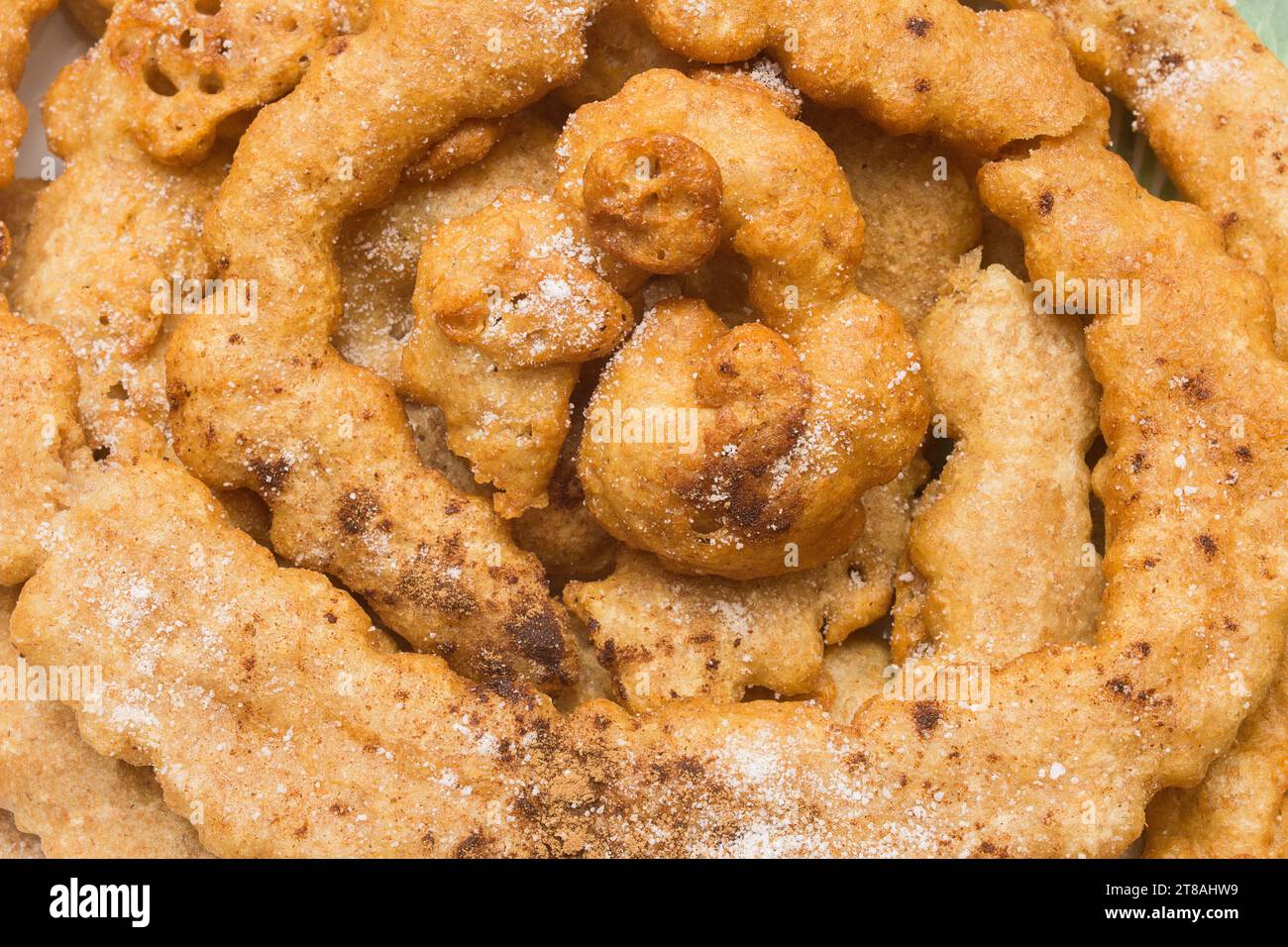 Overhead view closeup of a Spanish goldenbrown funnel cake covered in