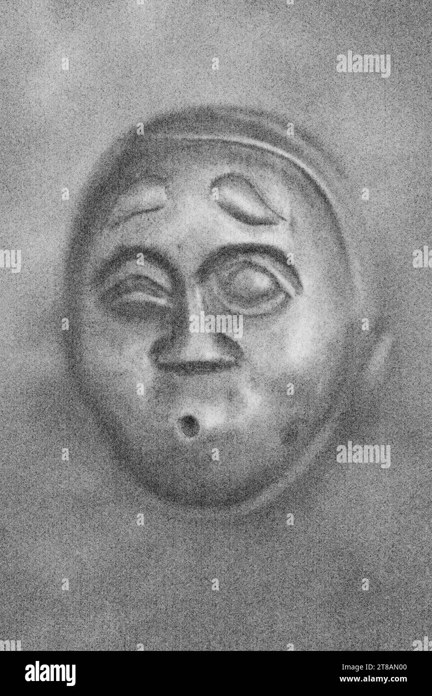 Soft and pencil like black and white image of wooden netsuke face or medieval man showing surprise or doubt Stock Photo