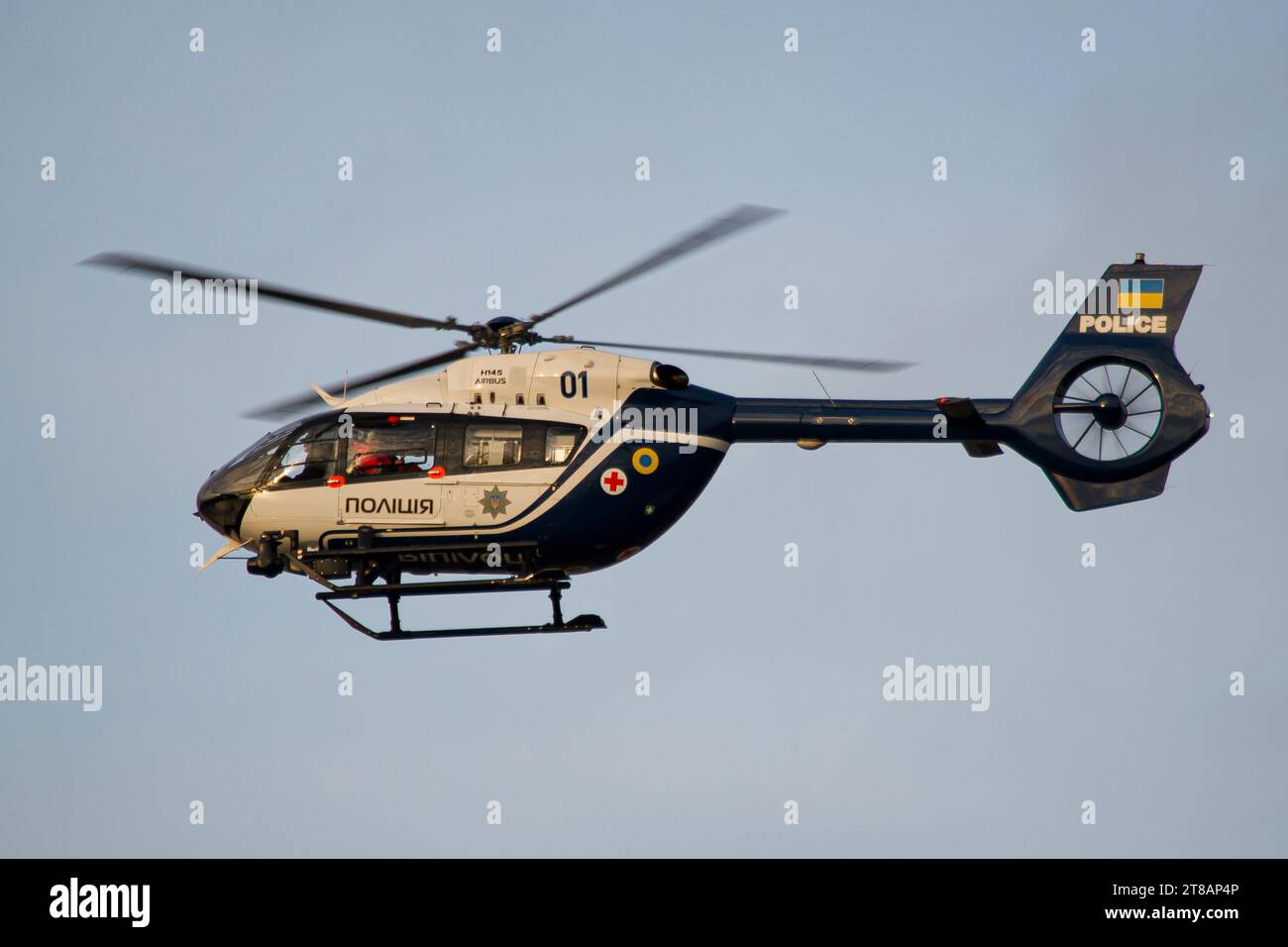 Ukrainian Natiomal Police helicopter Airbus H145 landing in Lviv International Airport during golden hour Stock Photo
