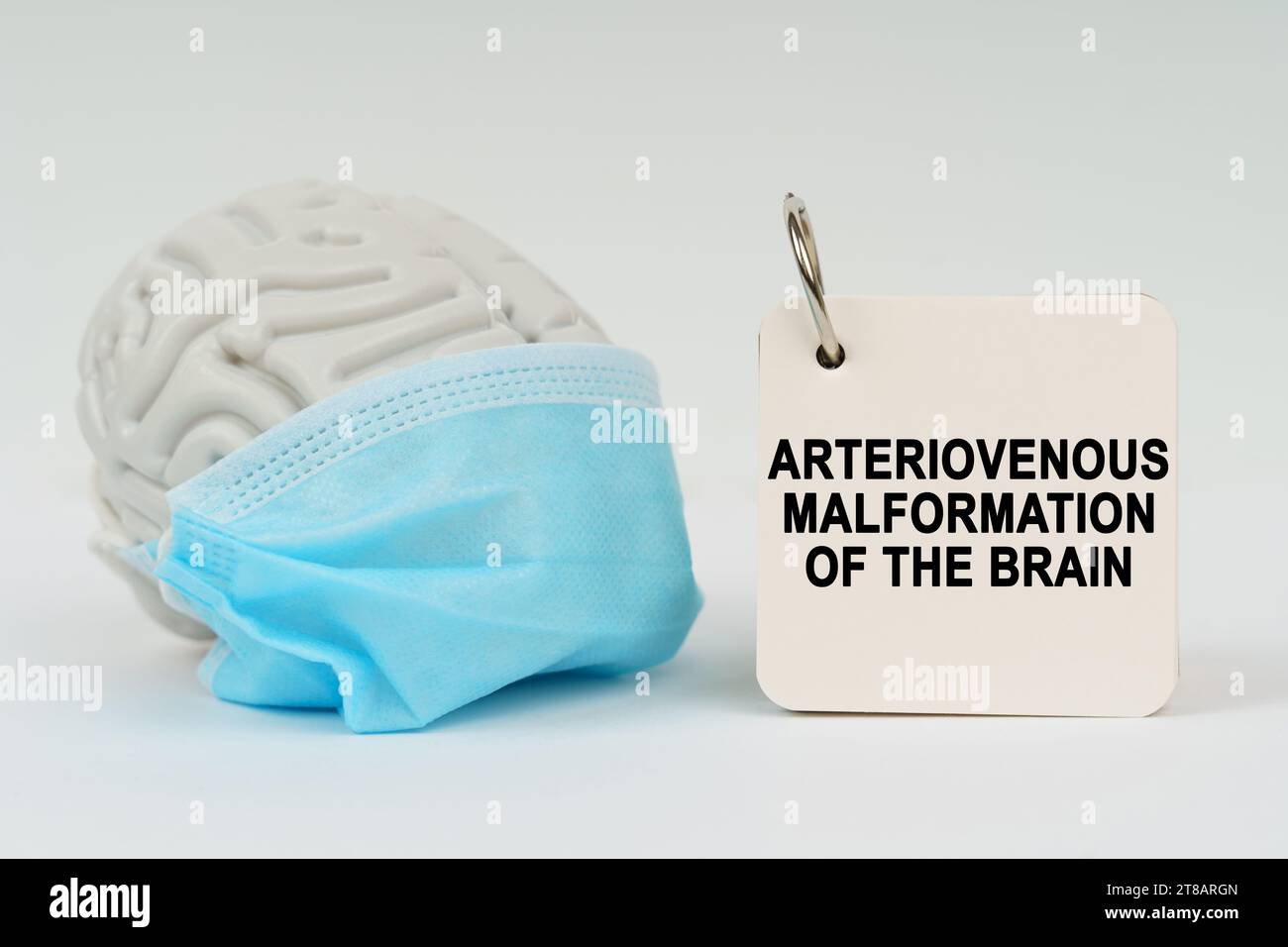 Medical concept. On a white surface there is a brain with a blue mask