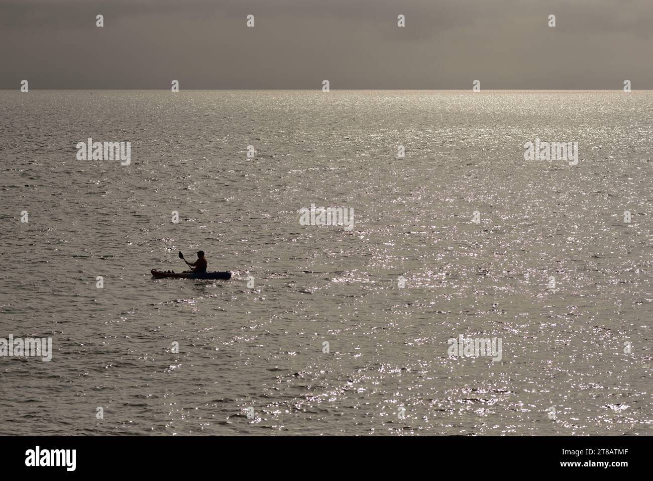 A lone canoeist in an open sea. Stock Photo