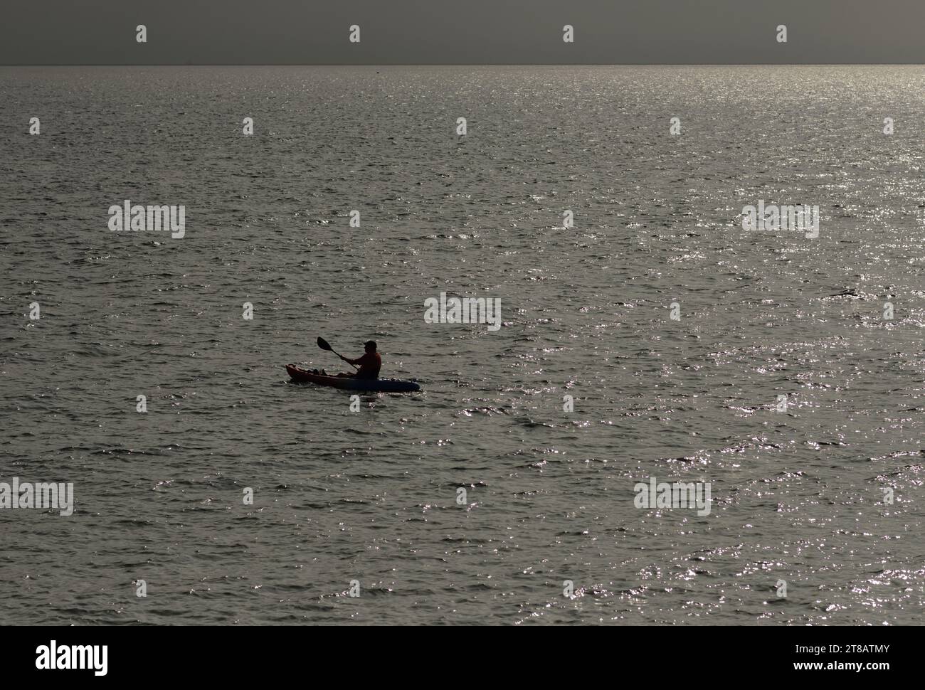 A lone canoeist in an open sea. Stock Photo