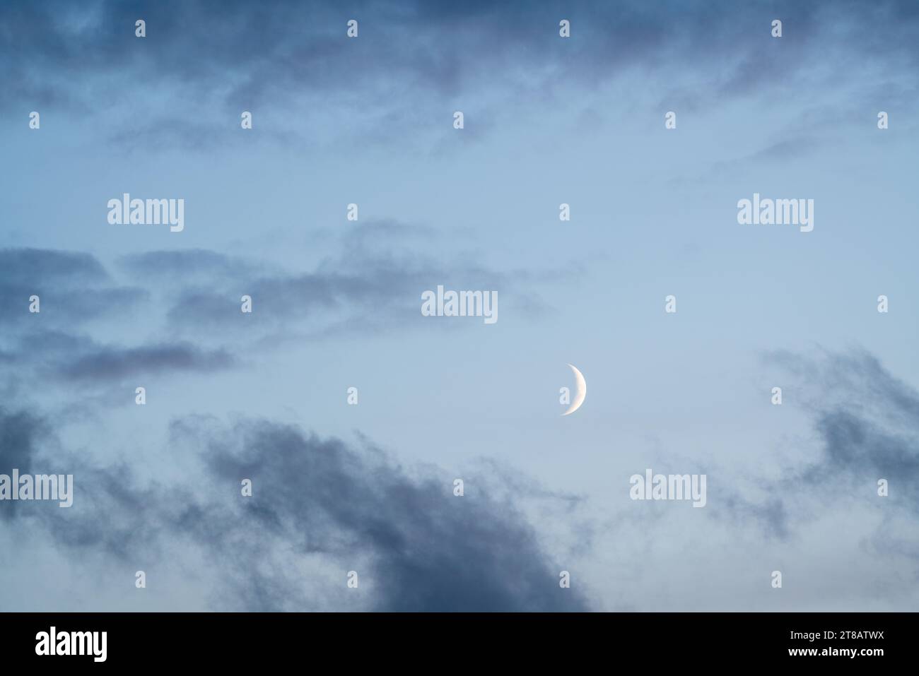 Dark clouds whit a have moon in the blue sky in the evening Stock Photo