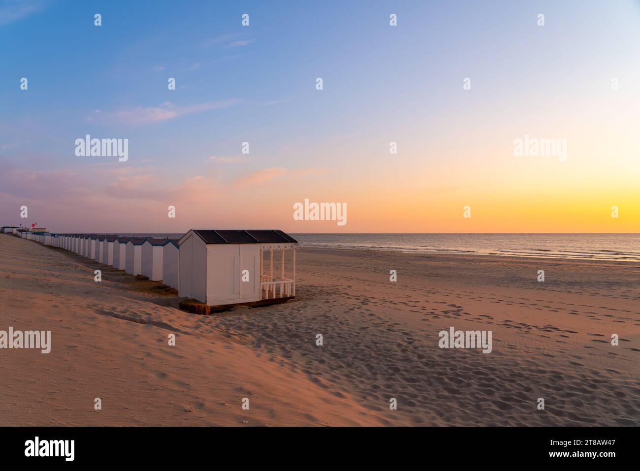 By the sea there is a row of beach huts side by side ,whit the sun go down Stock Photo