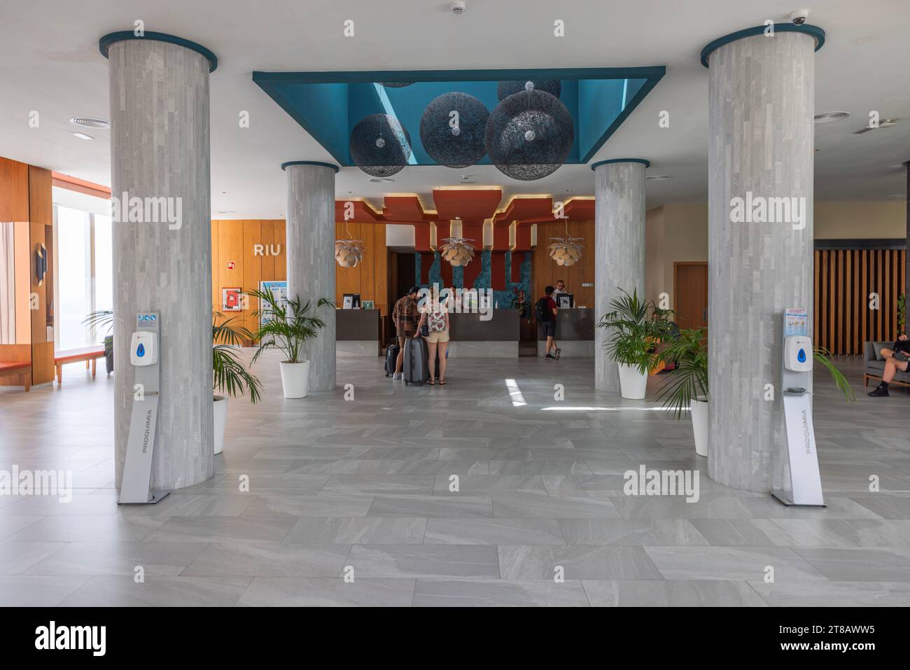 View of hotel lobby with reception area where tourists check in for rooms accommodation. Gran Canaria, Spain. Stock Photo