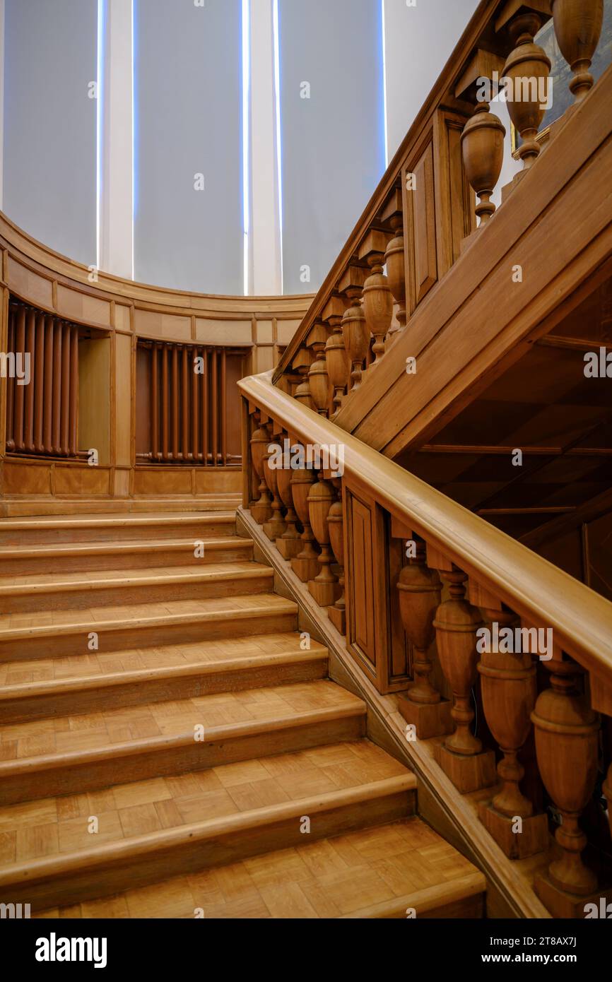 Wooden railings and wooden stairs in the interior of a spacious ...