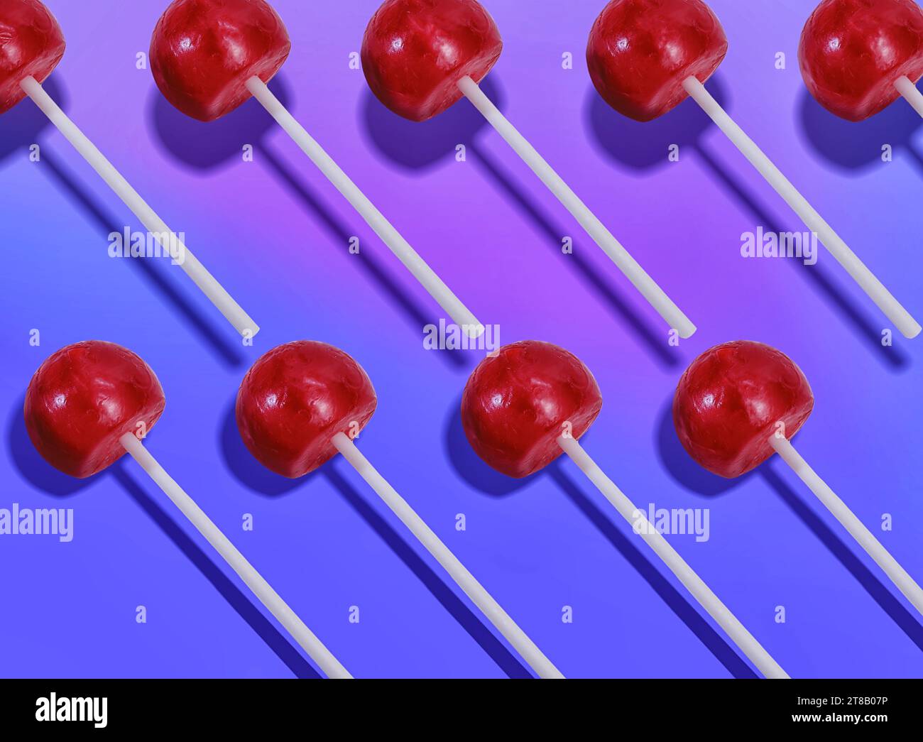 Array of Shiny Red Lollipops on a Saturated Blue Backdrop - Graphic ...