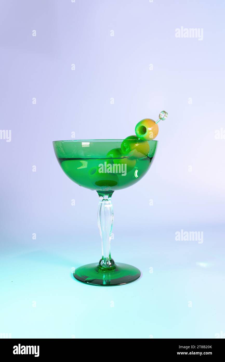 The Perfectly Mixed Dirty Martini with Olives in a Chic Art Deco Glass Stock Photo
