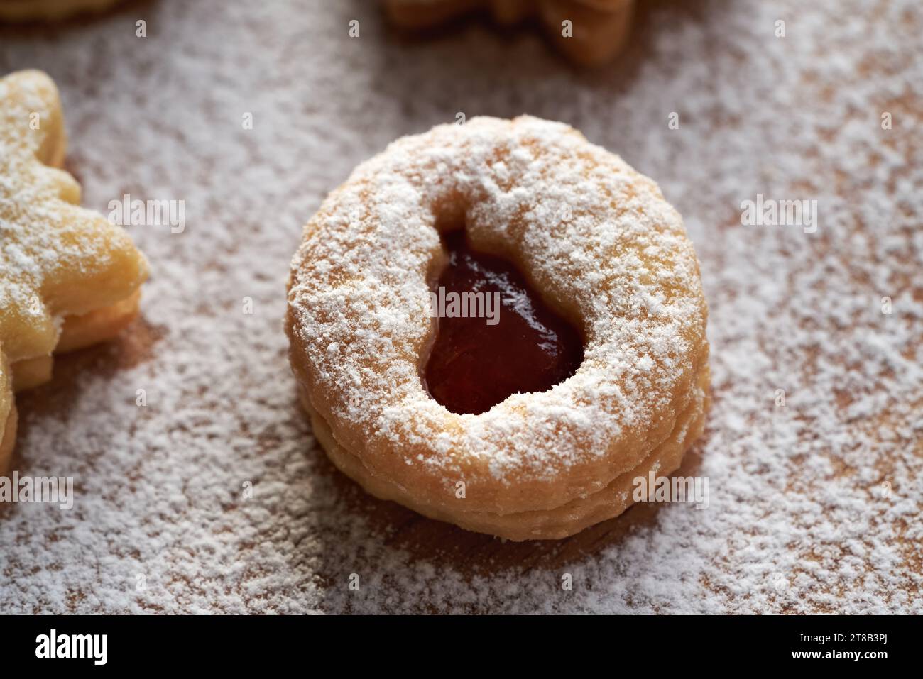 Circle shaped Linzer Christmas cookie filled with fruit jam and dusted with sugar Stock Photo