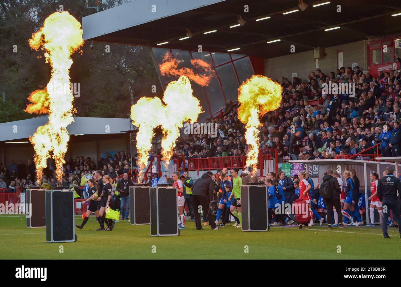 Crawley UK 19th November 2023 -  The teams walk out to a flaming reception in the Barclays  Women's Super League football match between Brighton & Hove Albion and Arsenal at The Broadfield Stadium in Crawley  : Credit Simon Dack /TPI/ Alamy Live News Stock Photo
