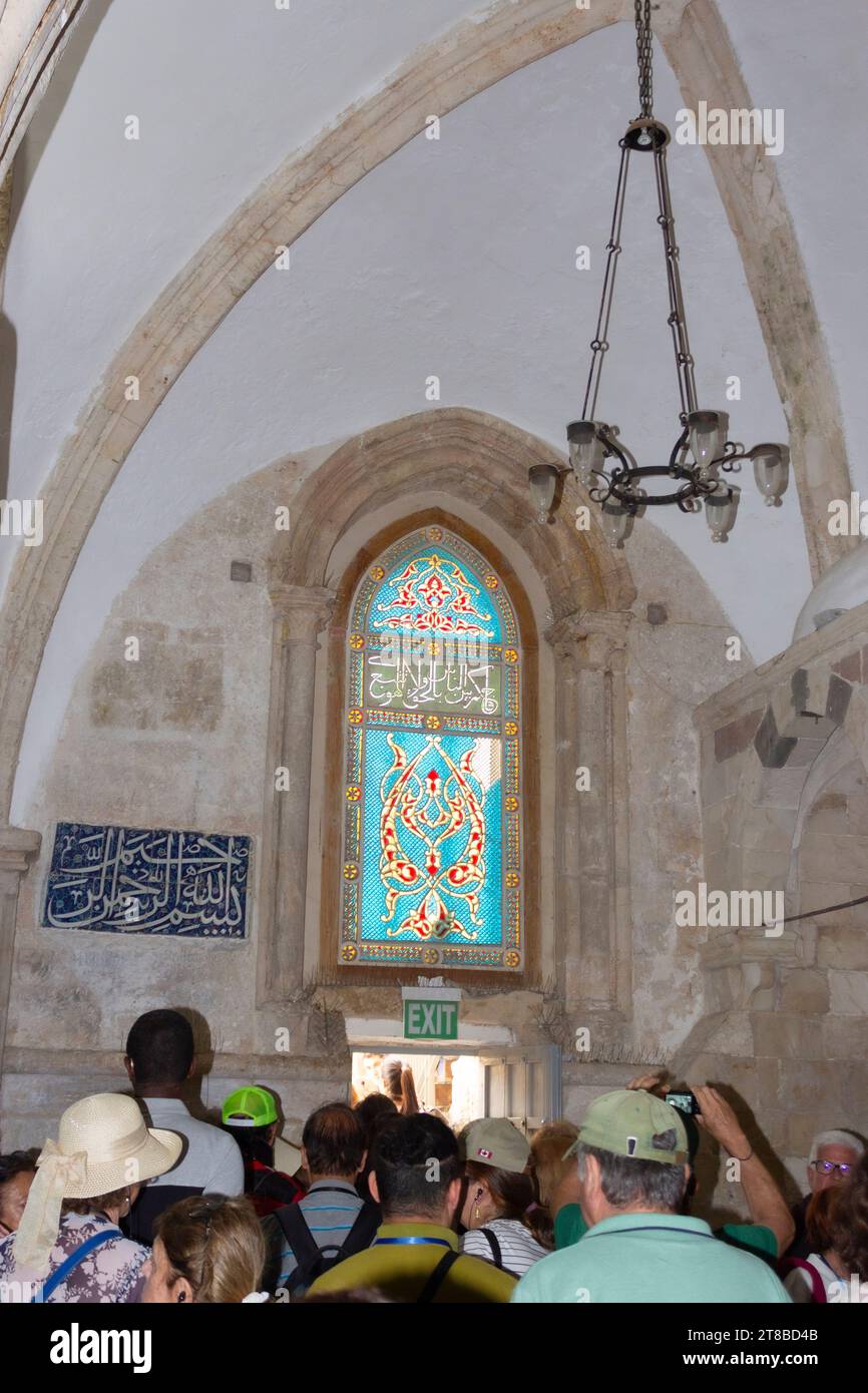 Mount Zion, Jerusalem, Israel.  Man praying in the Cenacle, aka the Upper Room, traditionally held to be the site of the Last Supper. Detail of staine Stock Photo