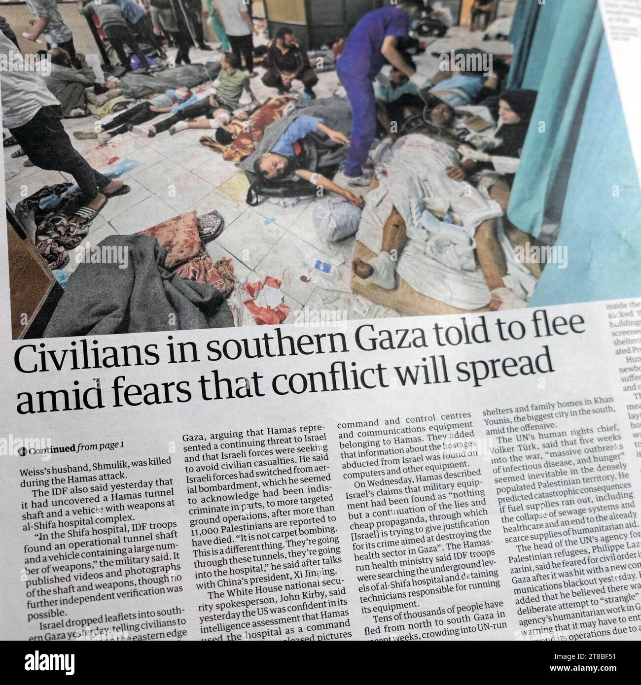 'Civilians in southern Gaza told to flee amid fears that conflict will spread' Guardian newspaper headline Israel Hamas war Shifa Hospital article UK Stock Photo