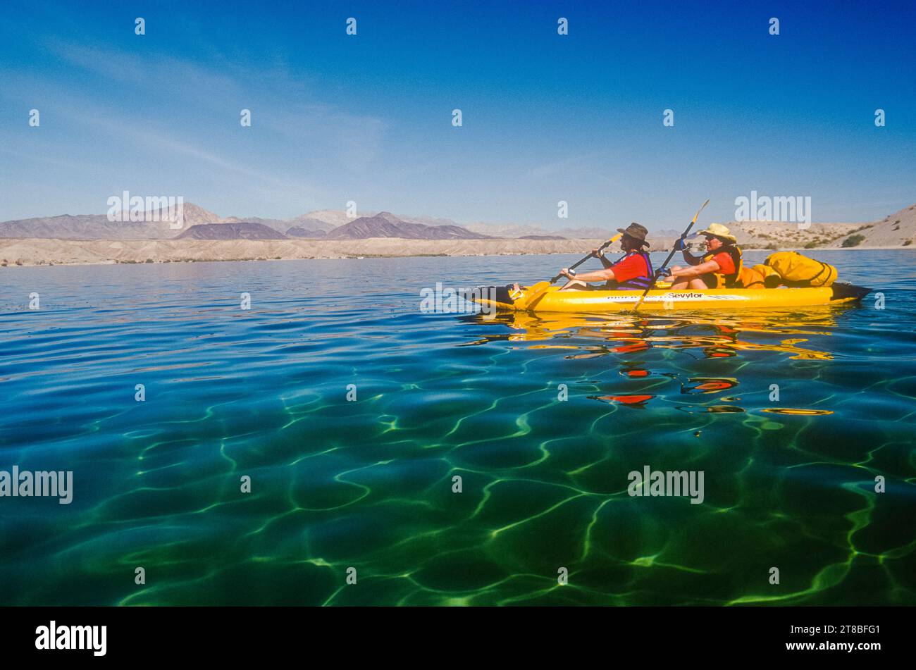 Jay Holiday & Julie Quarry kayak on the shore of Lake Mohave, Colorado River, Arizona Stock Photo