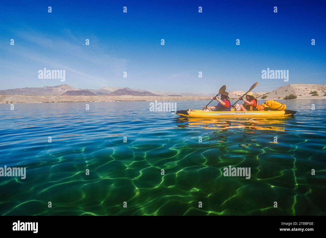 Jay Holiday & Julie Quarry kayak on the shore of Lake Mohave, Colorado River, Arizona Stock Photo