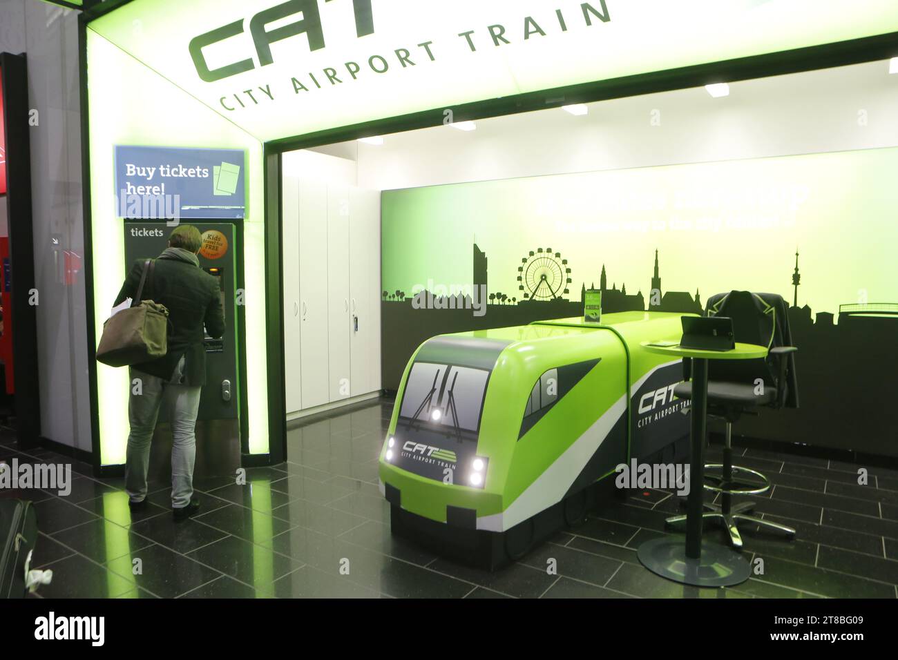 Passenger buys ticket for Vienna City Airport Train express connection, briging passengers from Airport to Wien Mitte department store in down town. Stock Photo