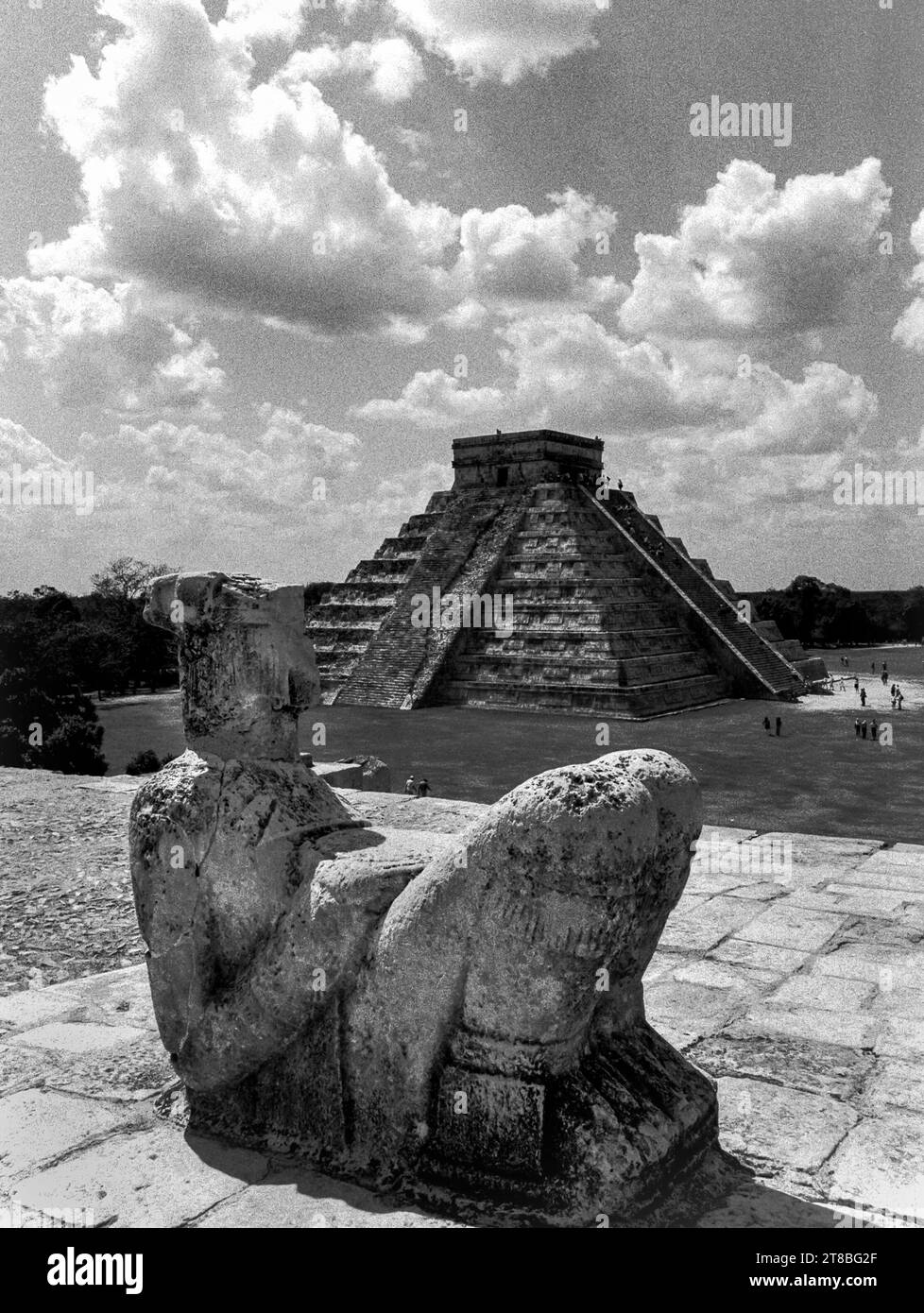 Mexico, Yucatan, Chichen Itza:The Mayan Chac Mool statue in the foreground and the pyramid of Temple of the Warriors in the background Stock Photo