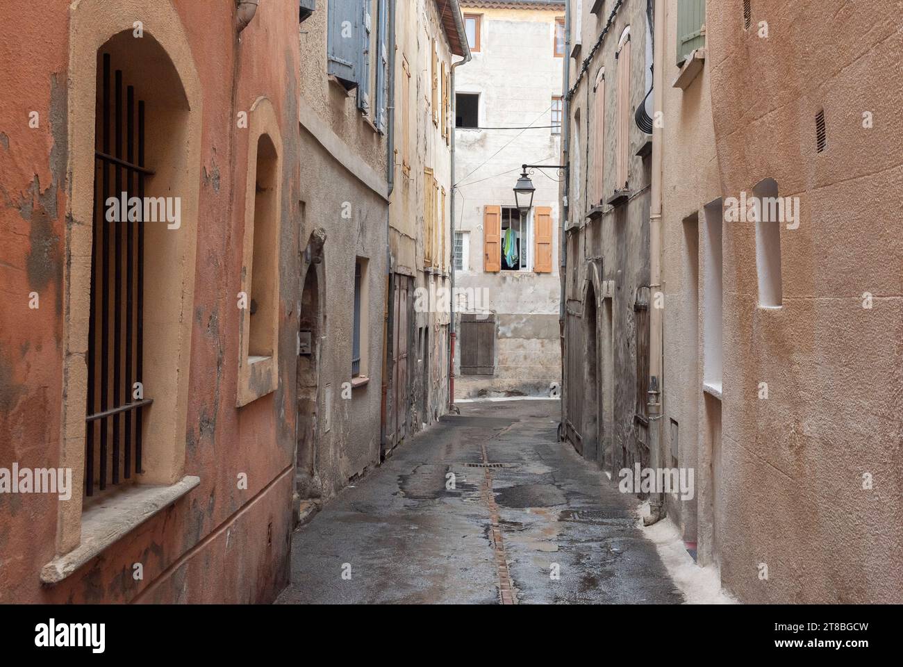 Narrow side alleys in the historic city center of Manosque, France on a cloudy and rainy day Stock Photo