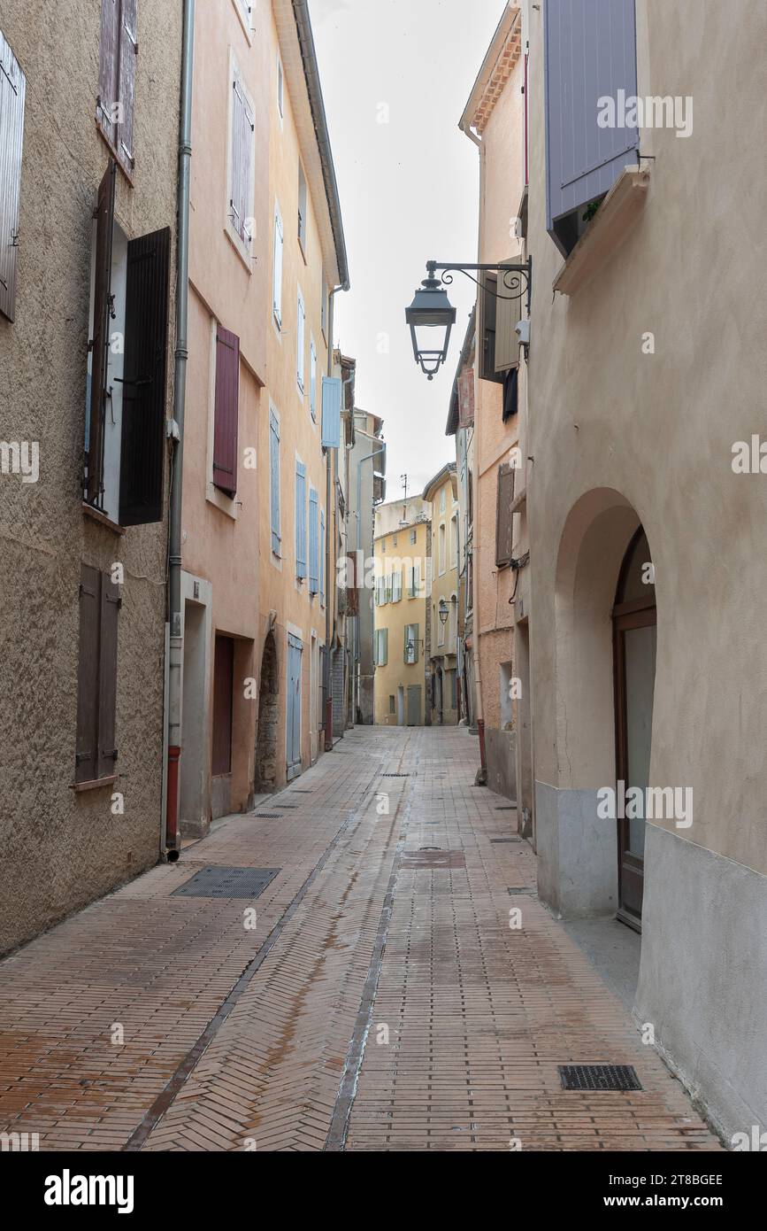 Narrow side alleys in the historic city center of Manosque, France on a cloudy and rainy day Stock Photo