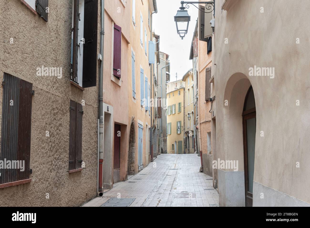 Narrow side alleys in the historic city center of Manosque, France on a cloudy and rainy day Stock Photo