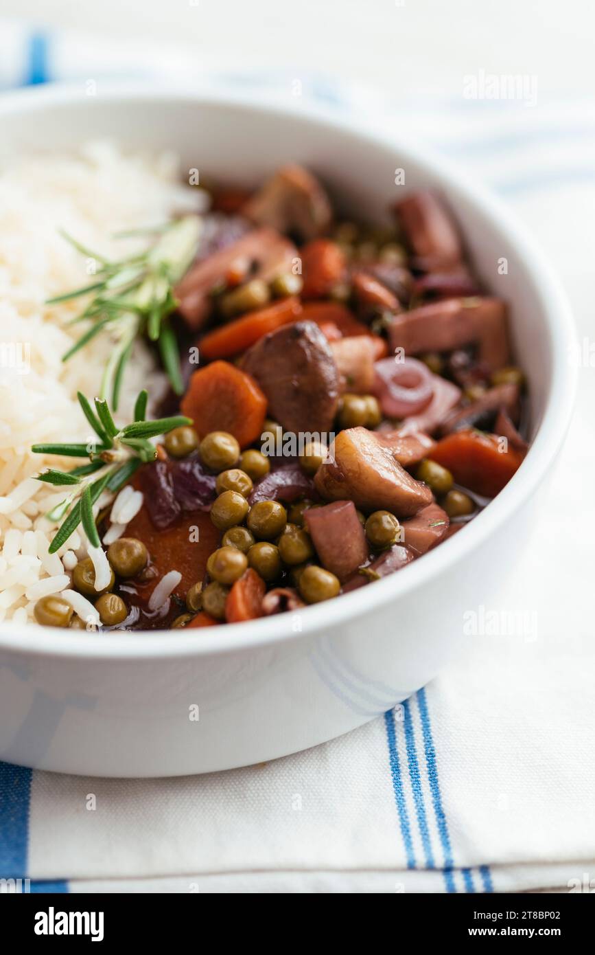 Vegan Mushroom Bourgogne with peas and carrots on rice Stock Photo