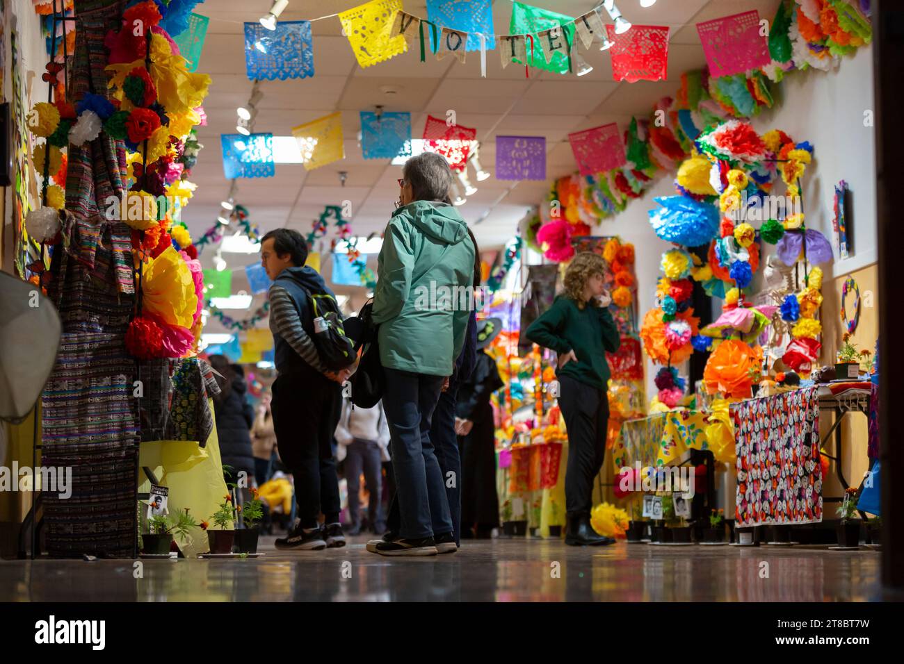 Visitors consider a series of ofrendas at El Centro de la Raza’s annual