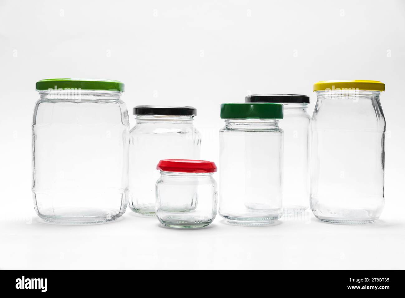 Collection of empty glass jars with lids isolated on white background