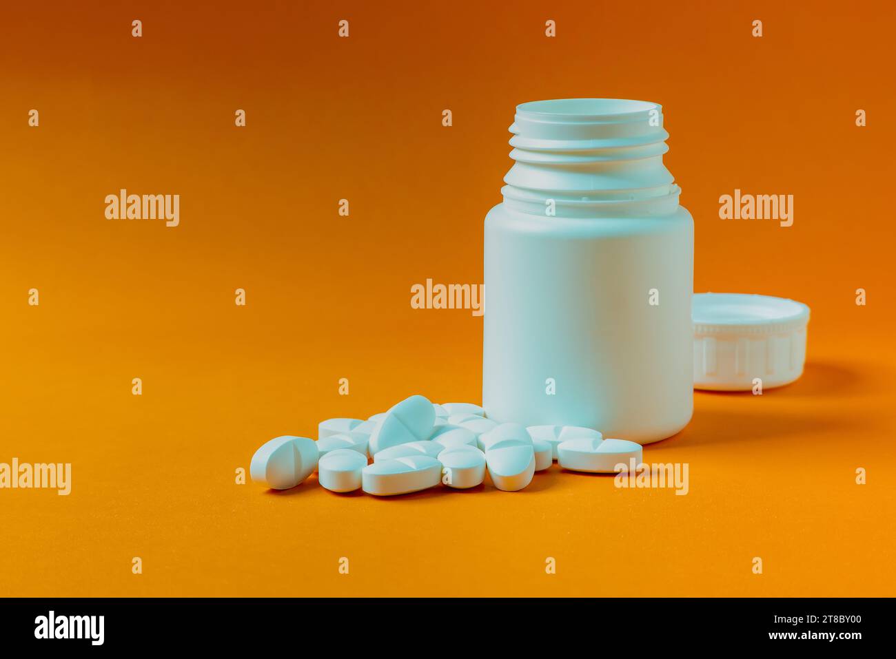 Pill container on an orange background Stock Photo Alamy