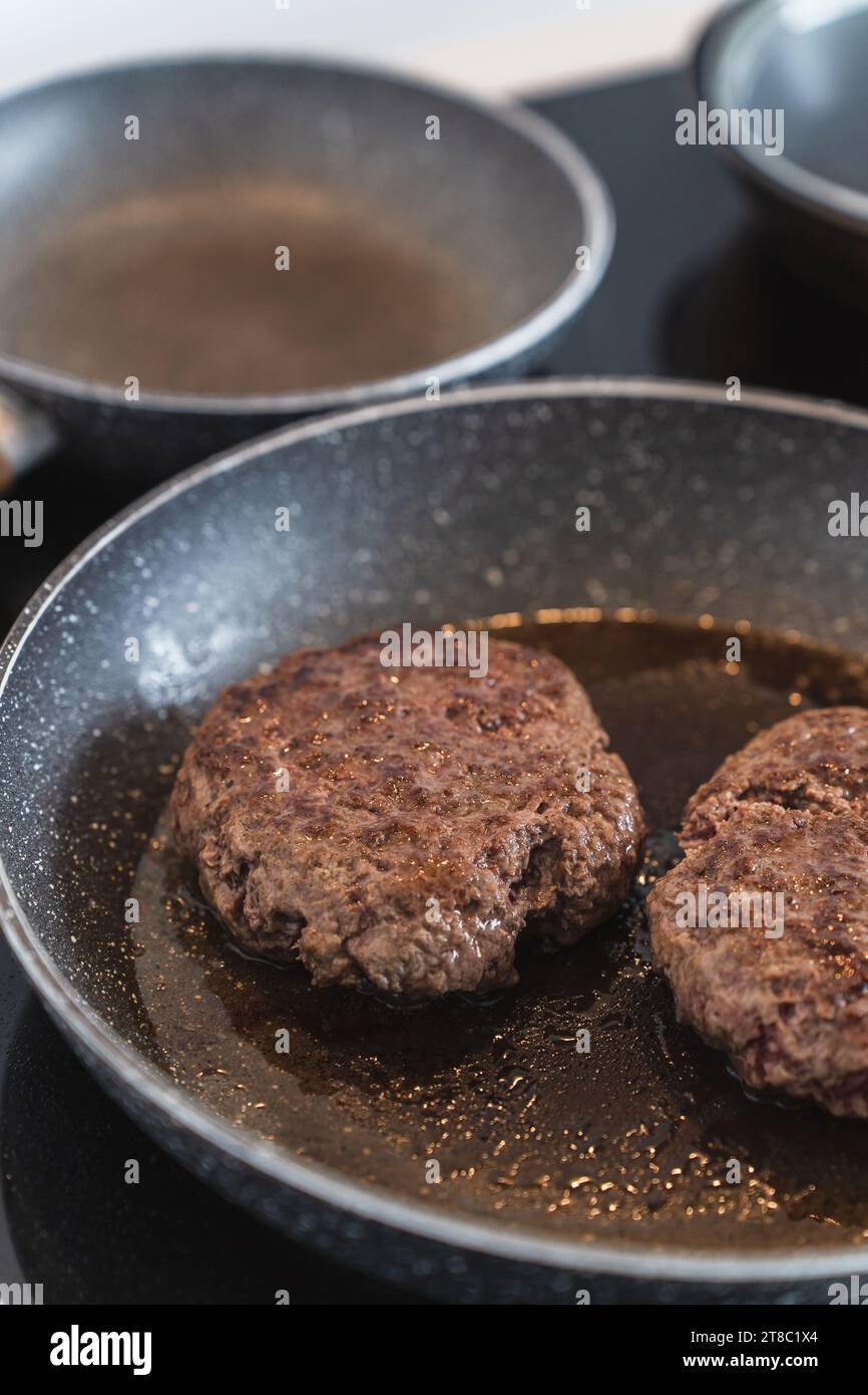 Juicy ground beef hamburger patty sizzling and cooking to perfection