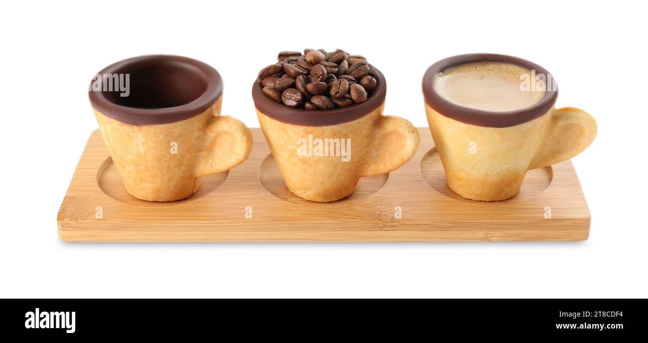 Edible biscuit cups with espresso, coffee beans and empty one on white