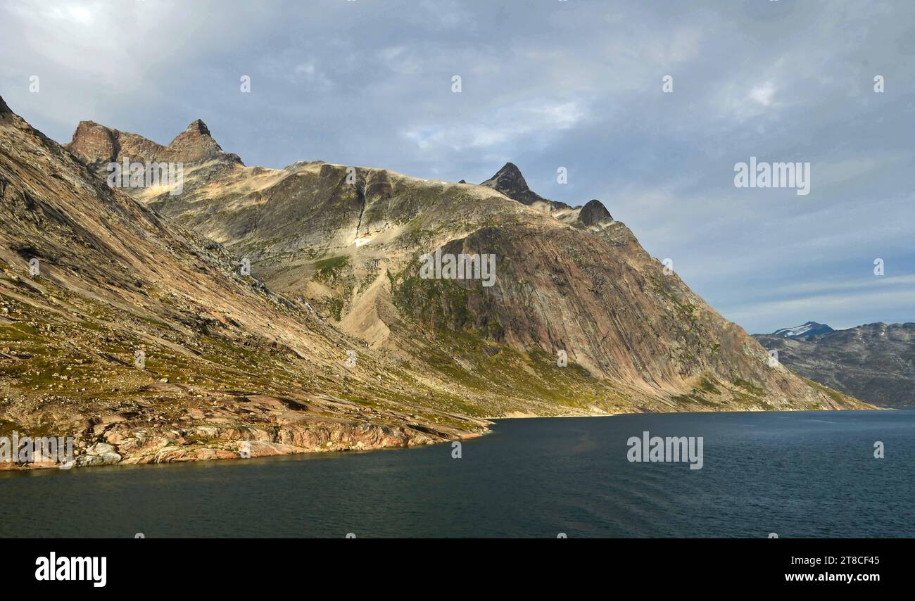 the steep, glaciated granite peaks of the western side of the prince christian sound, in southern greenland, from a cruise ship Stock Photo