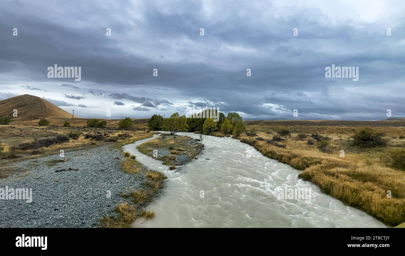 Flooded stream on the winding narrow gravel road between Lake Tekapo ...