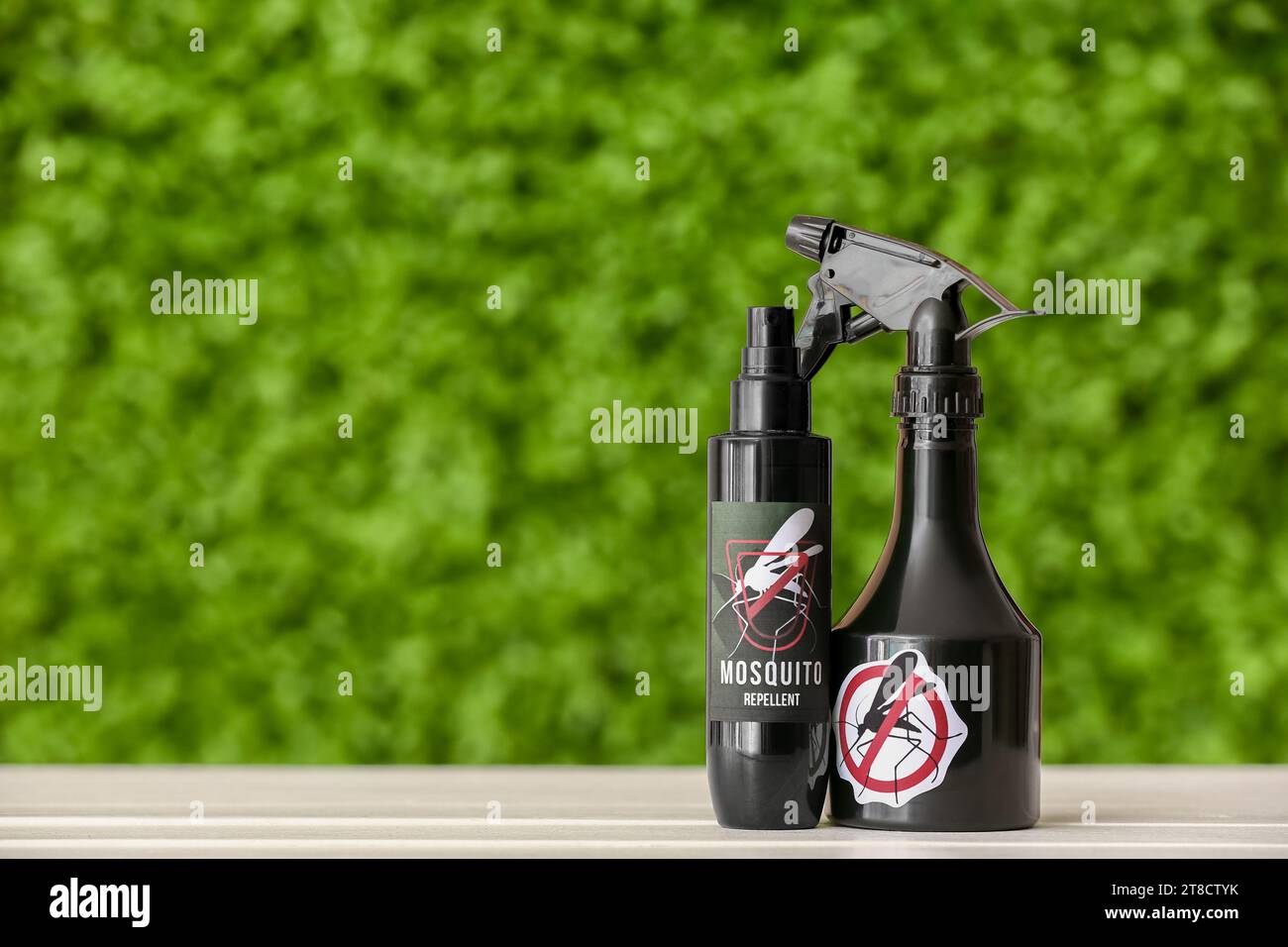 Spray bottles of mosquito repellent on table outdoors Stock Photo - Alamy