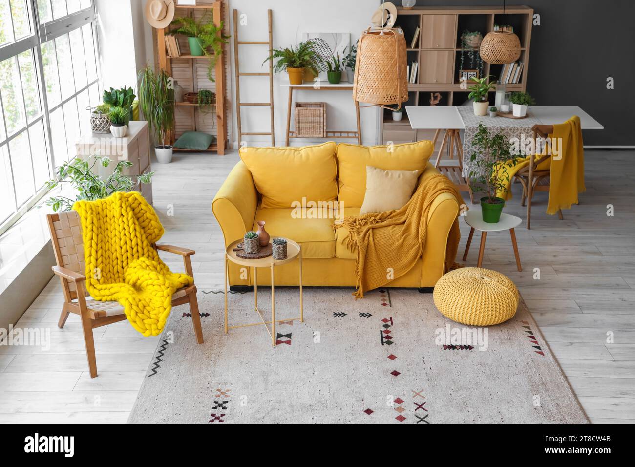 Interior of modern living room with yellow sofa, armchair and ...