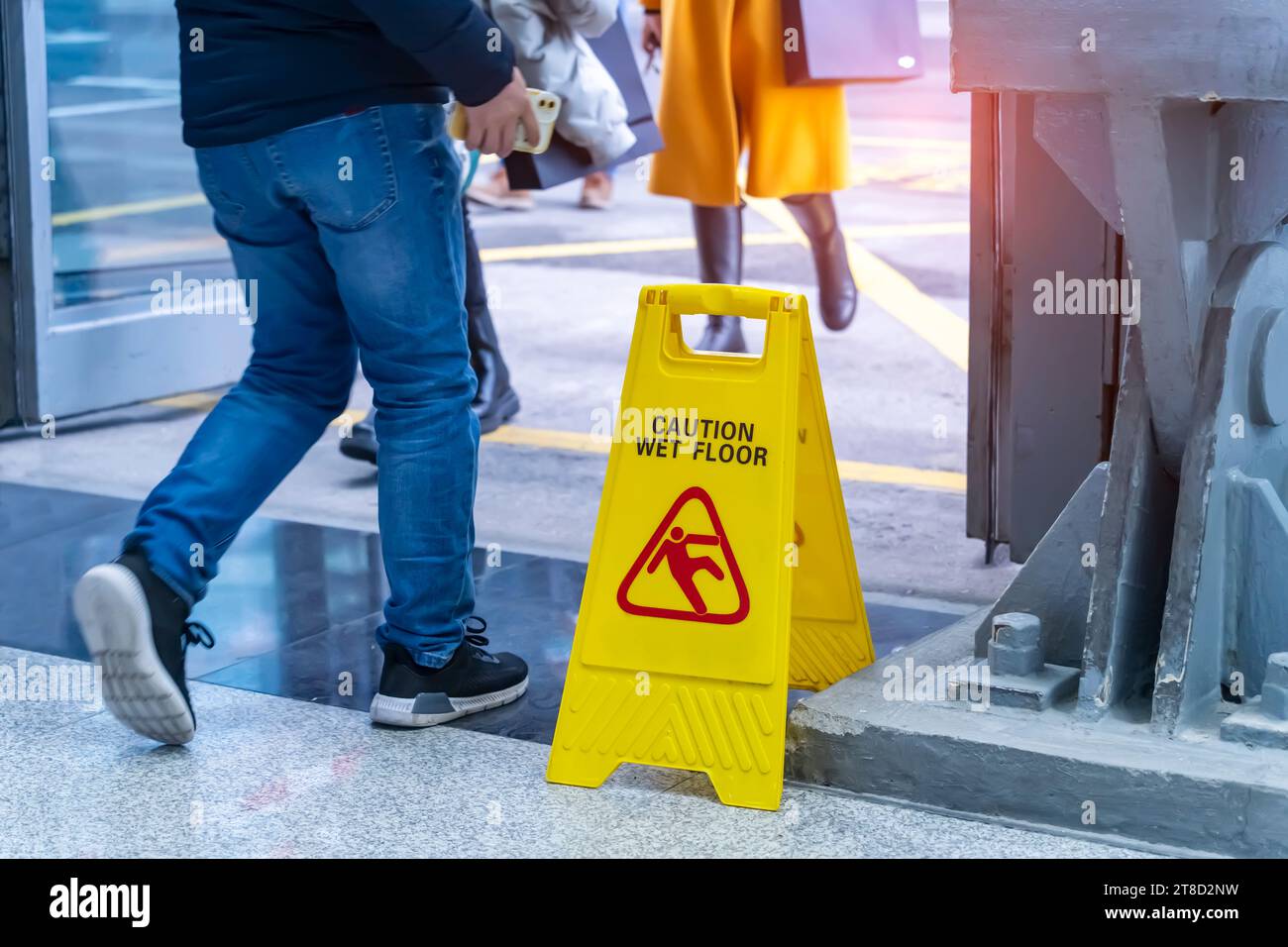 Caution wet floor sign on wet floor Stock Photo