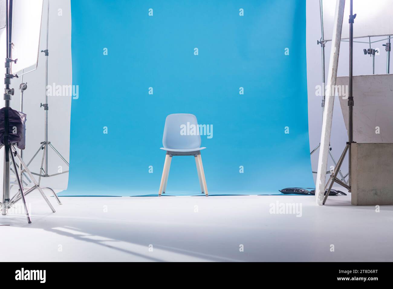 Blue classic chair on the blue backdrop for Chroma Key technique in the photo shooting studio for filmmaking. Stock Photo