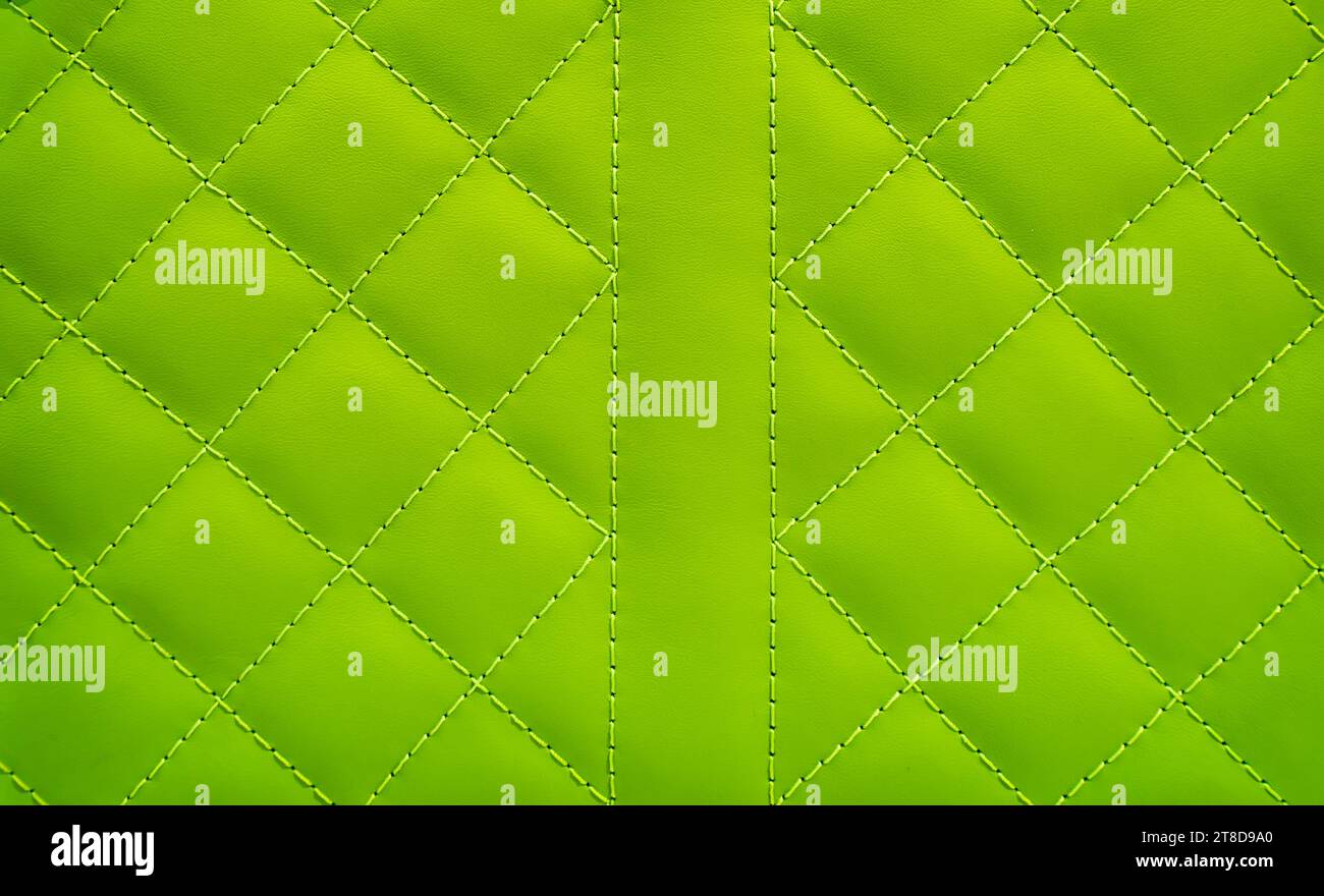 green leather background and texture as a pattern for the interior car or a sofa or wall covering Stock Photo