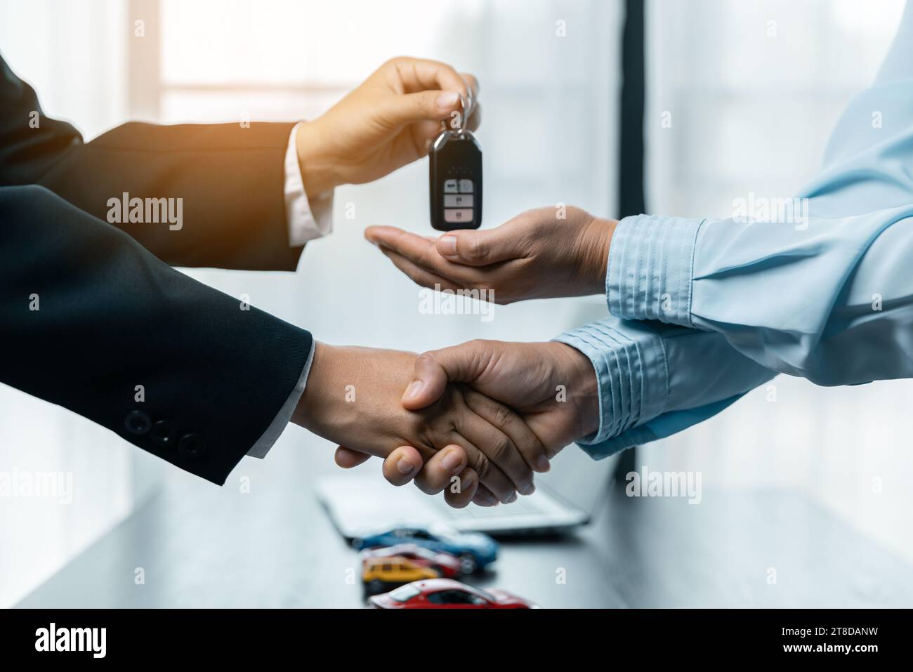 Toy Car In Front Of Businessman Calculating Loan. Saving money for car concept, trade car for