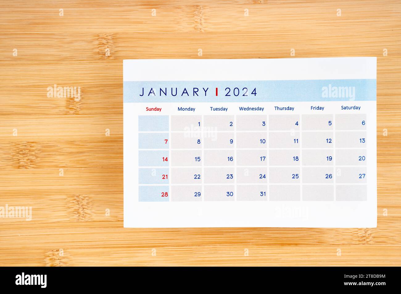 Jauary 2024 calendar page on wooden background with empty space Stock Jauary 2024 calendar page on wooden background with empty space Stock