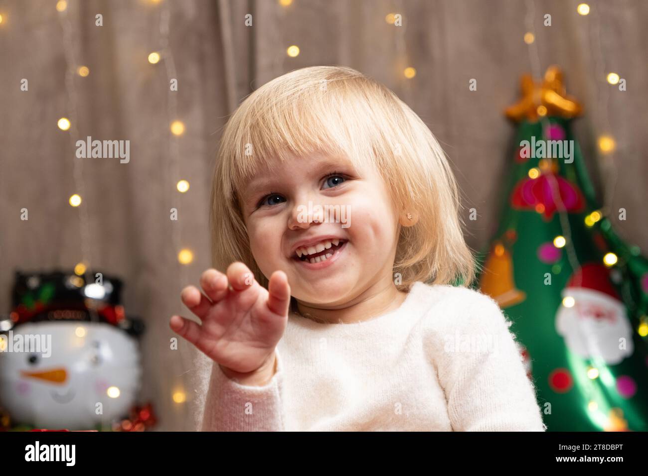 Portrait of two year old little Christmas blonde girl with blue eyes