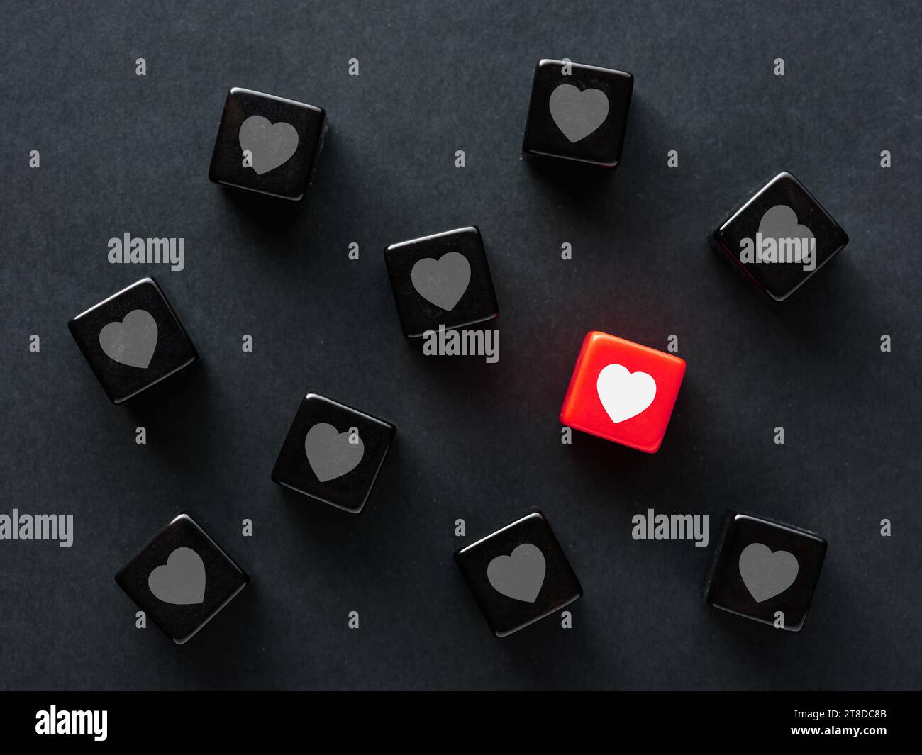 Finding a match in social media. To find love. Online love or matching in dating apps. Heart symbols on black cubes Stock Photo