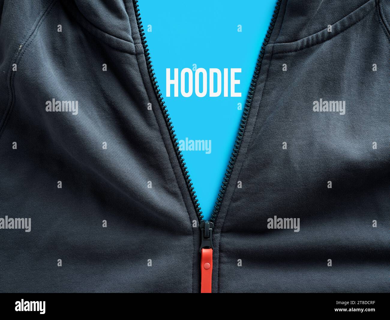 Opened zipper of a hoodie showing the word hoodie on a blue tag. Casual sportswear clothing concept. Stock Photo