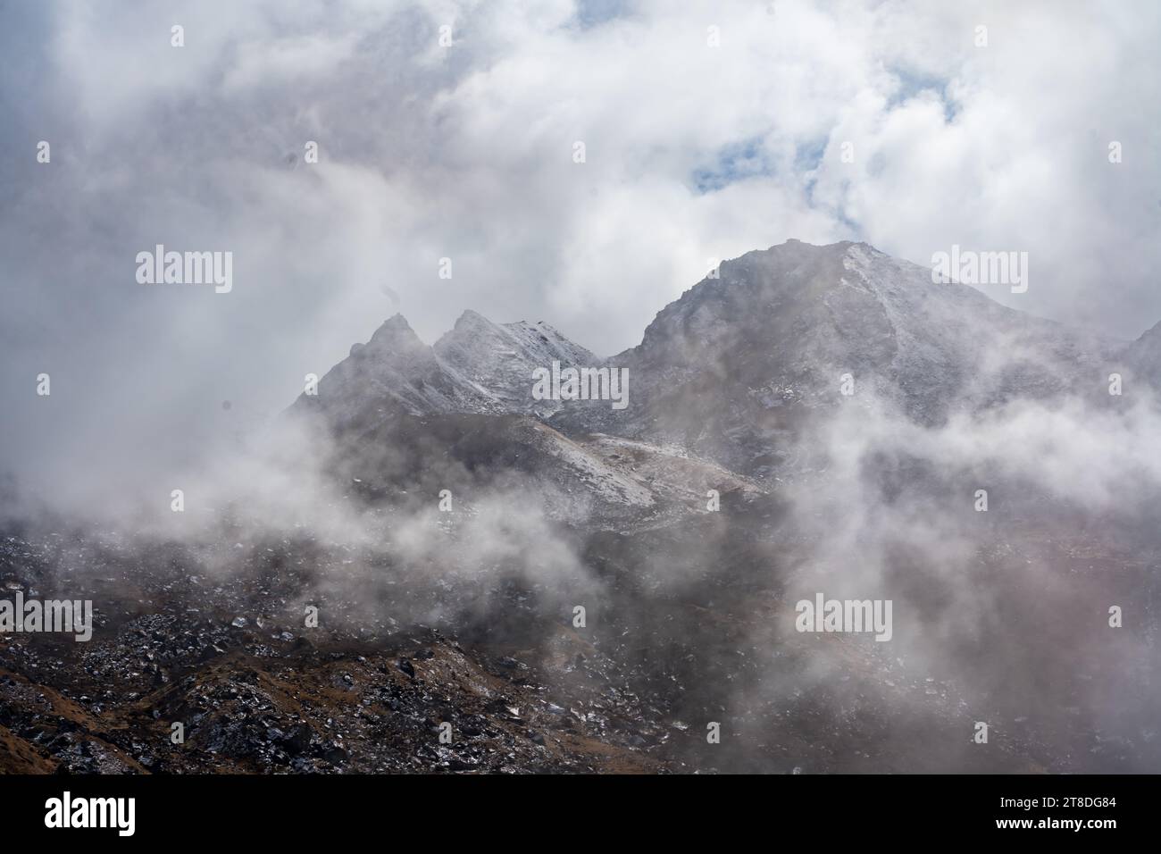Trekking in the Kanchenjunga Conservation Area with dark Cloudy Himalyaan Mountains, Forest, Village Stock Photo