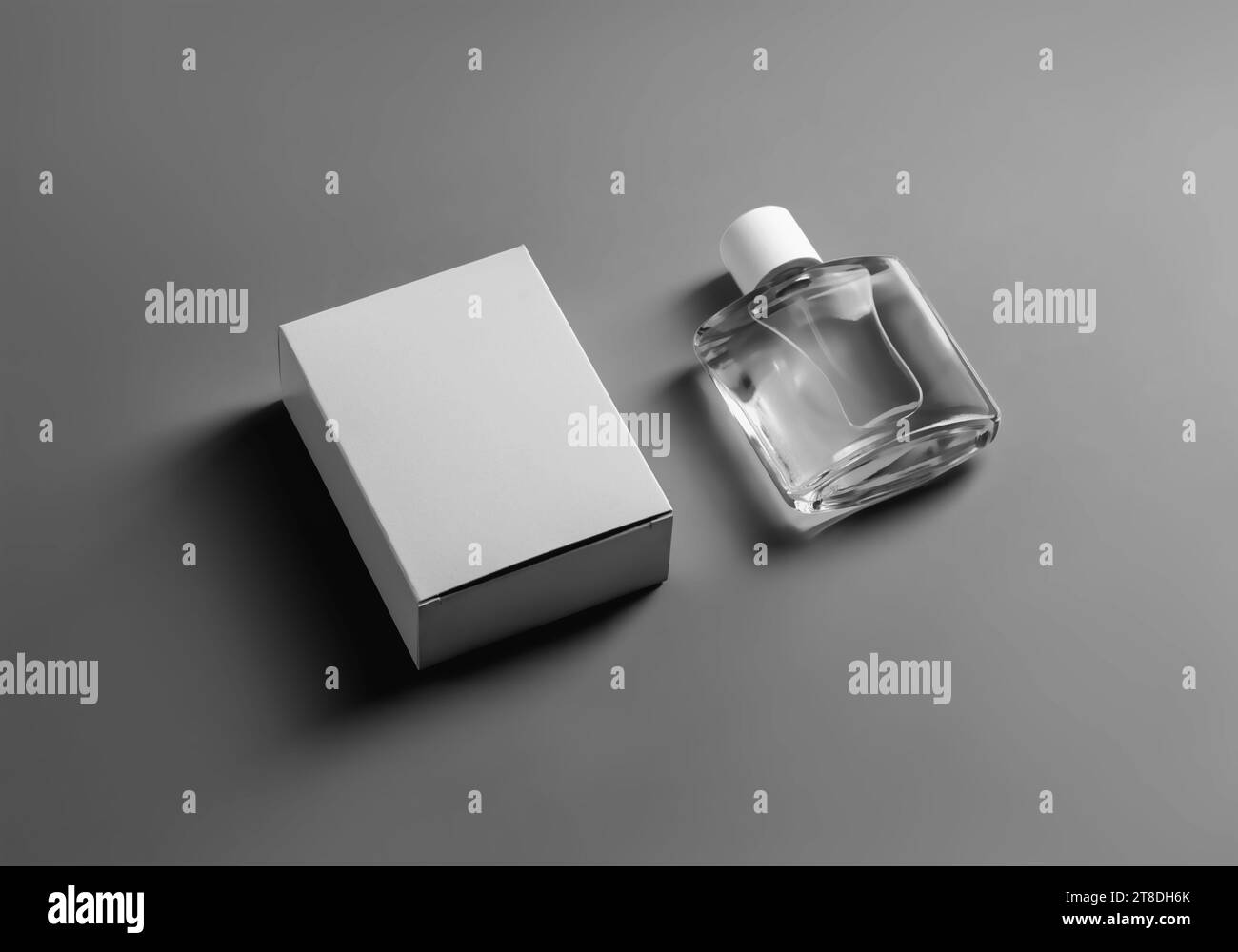 Mockup of a white box, transparent perfume bottle, isolated on background with shadows. Fashionable packaging template with aromatic liquid. Product p Stock Photo