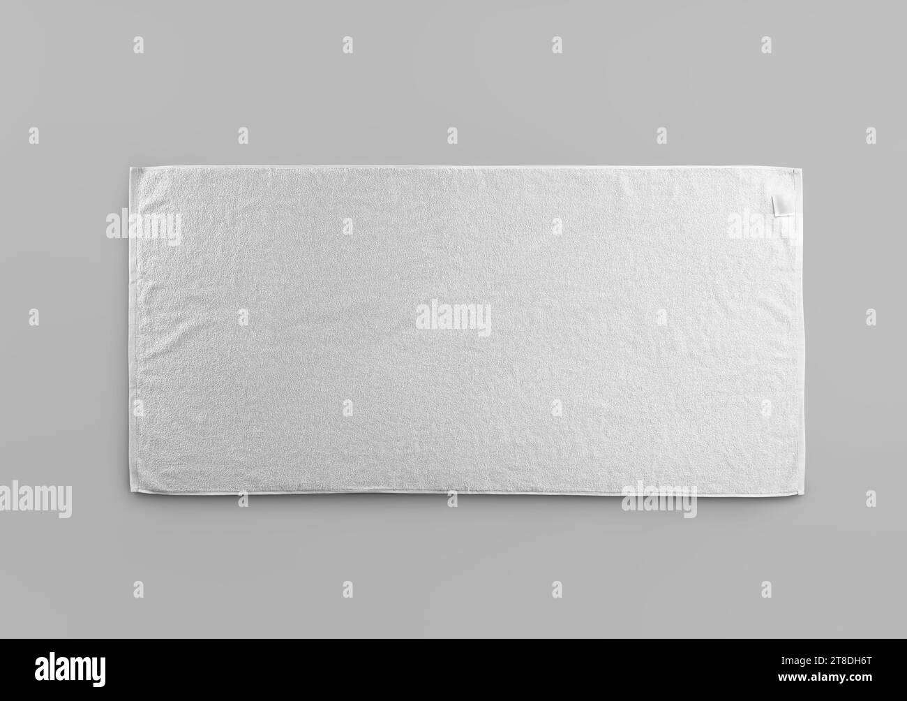 Mockup of white terry towel with label isolated on background. Fashionable laid out towelling template for wiping, for branding, design. Product photo Stock Photo