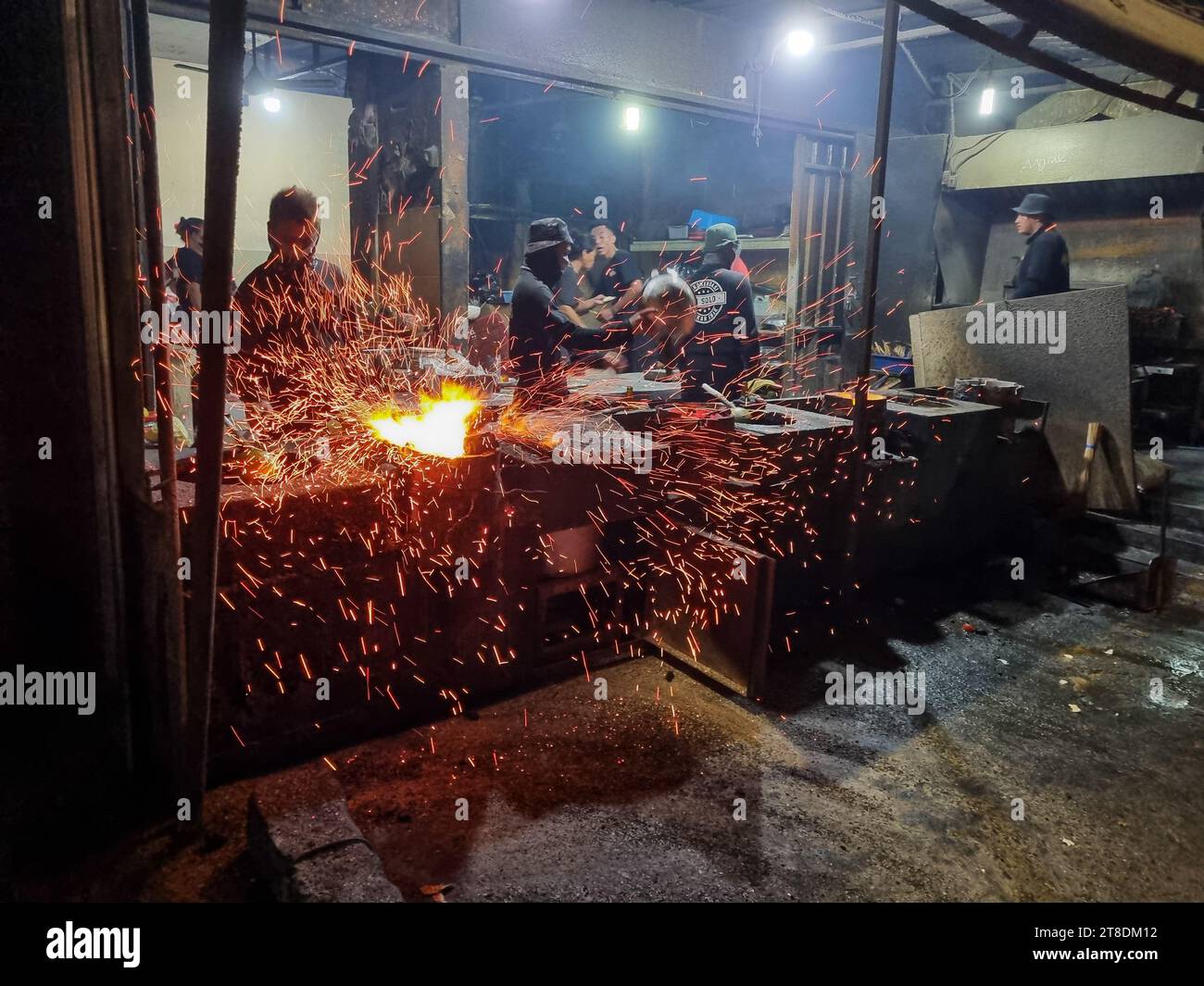 Sparks from a traditional stove and a cooker cooking on the stove Stock