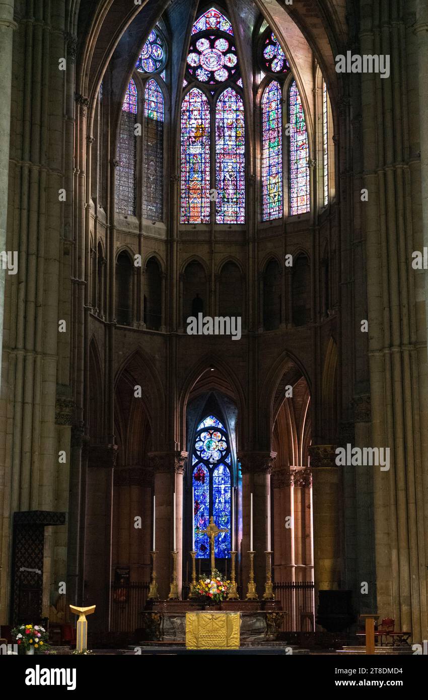 An impressive architectural cathedral, with a multitude of pillars lining the exterior and a magnificent stained glass window visible inside Stock Photo