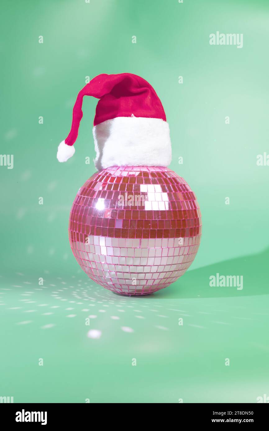 Holiday Party Ready Pink Disco Ball Wearing a Santa Hat CloseUp Shot